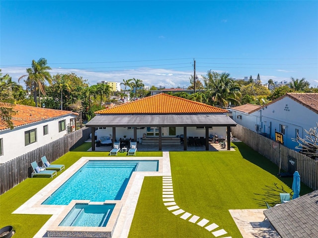 view of swimming pool featuring outdoor lounge area, a fenced backyard, and a lawn