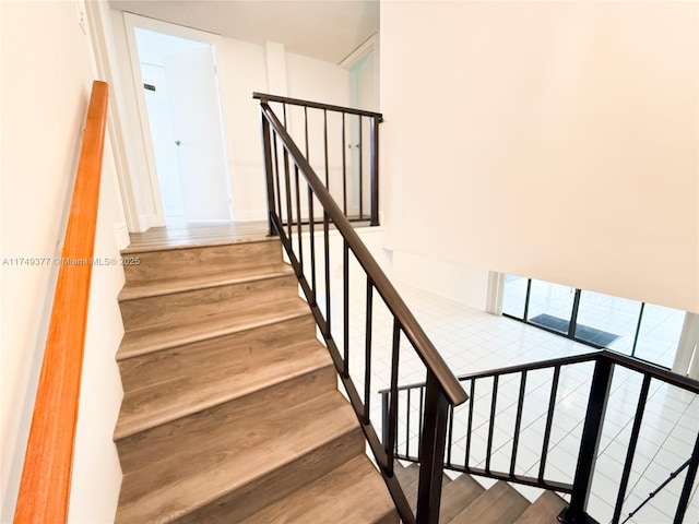 stairs featuring wood finished floors