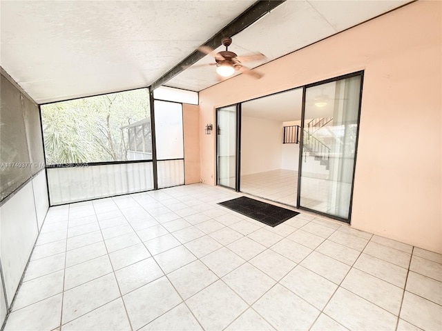 unfurnished sunroom with vaulted ceiling with beams and ceiling fan