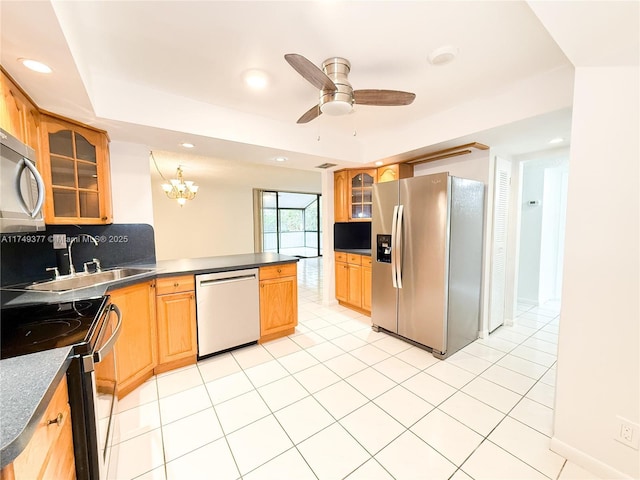 kitchen featuring light tile patterned floors, a peninsula, stainless steel appliances, glass insert cabinets, and dark countertops