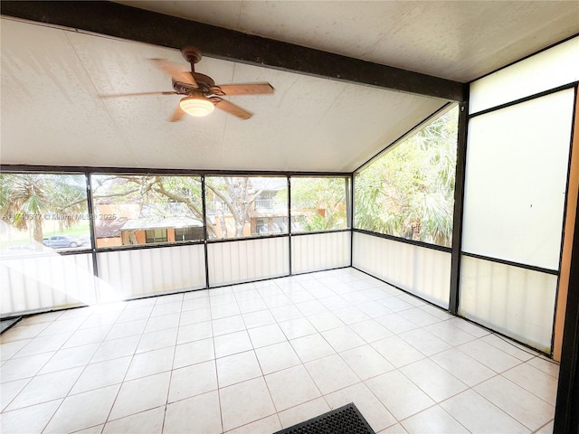 unfurnished sunroom featuring vaulted ceiling with beams and a ceiling fan