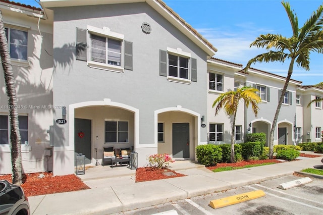 multi unit property with a tile roof and stucco siding