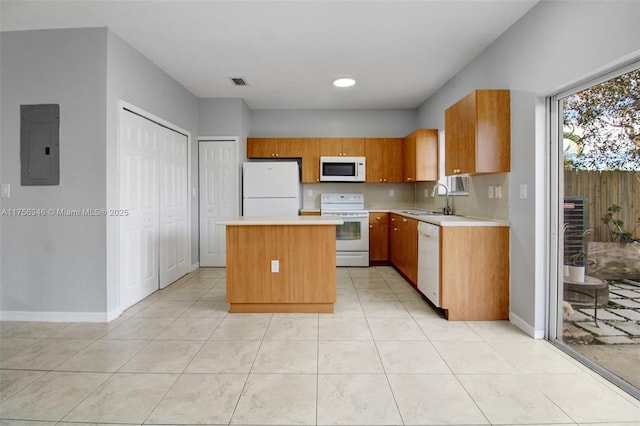 kitchen with white appliances, a kitchen island, a sink, light countertops, and electric panel