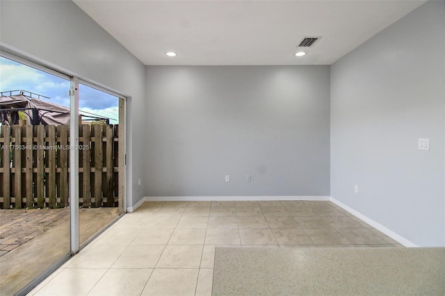 unfurnished room with baseboards, visible vents, and tile patterned flooring