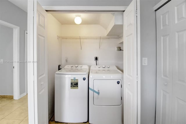 laundry area with laundry area, separate washer and dryer, and light tile patterned flooring