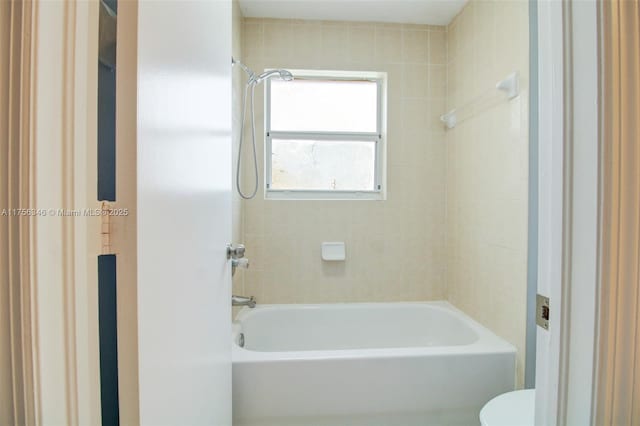 bathroom with shower / washtub combination and toilet