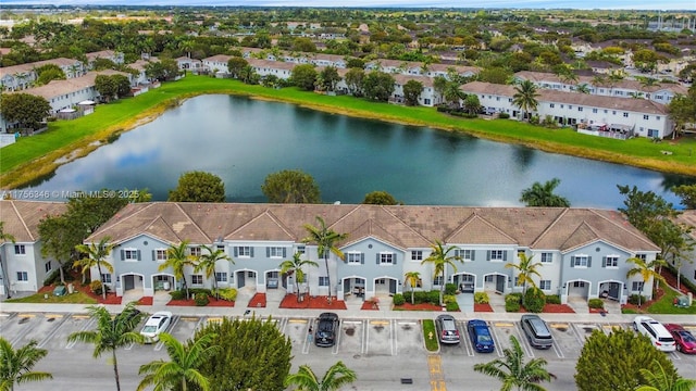 drone / aerial view featuring a water view and a residential view