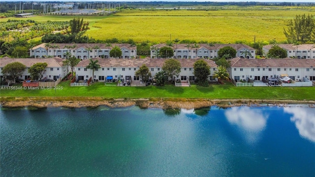 birds eye view of property with a water view and a residential view