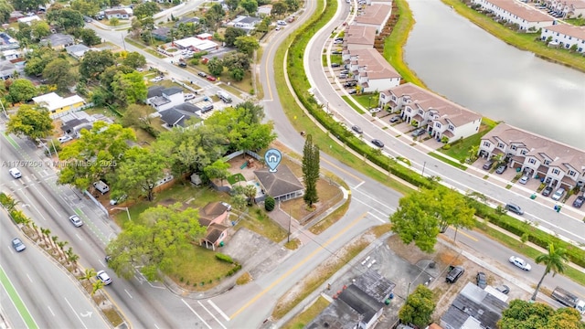 drone / aerial view with a residential view and a water view