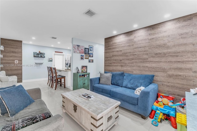 living room featuring light tile patterned flooring, visible vents, and recessed lighting