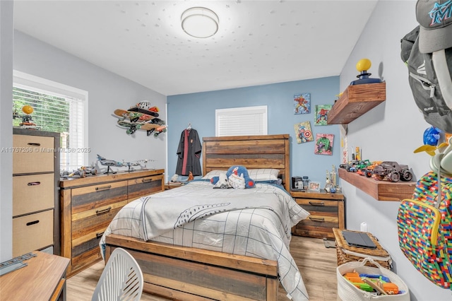 bedroom with light wood-style floors