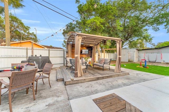 view of patio featuring outdoor dining space, grilling area, a fenced backyard, and an outdoor structure