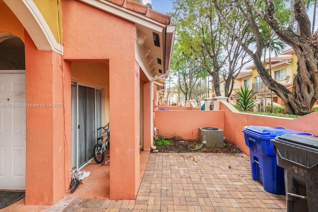 view of patio / terrace with central AC and fence