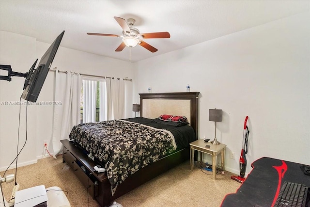 carpeted bedroom with ceiling fan and baseboards