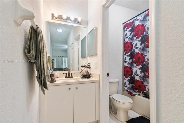 full bath with a textured wall, toilet, shower / tub combo, vanity, and tile patterned floors