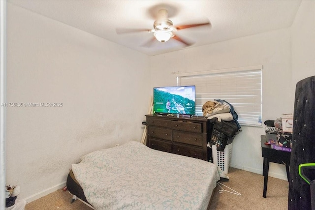 carpeted bedroom featuring a ceiling fan and baseboards