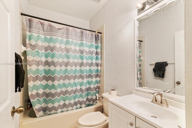 bathroom featuring toilet, shower / tub combo, vanity, and a textured wall