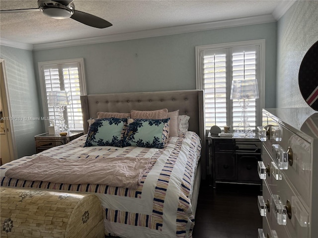 bedroom with a textured ceiling, wood finished floors, a ceiling fan, and crown molding