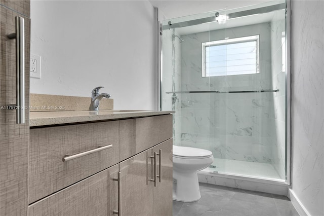 full bathroom with toilet, marble finish floor, a marble finish shower, and vanity