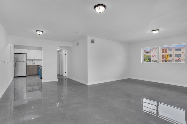 empty room featuring baseboards and visible vents