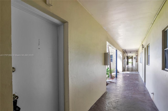 hall featuring concrete flooring