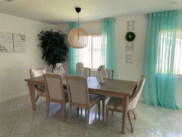 dining area with light tile patterned floors and baseboards