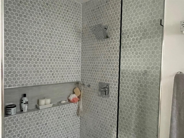 bathroom with a tile shower