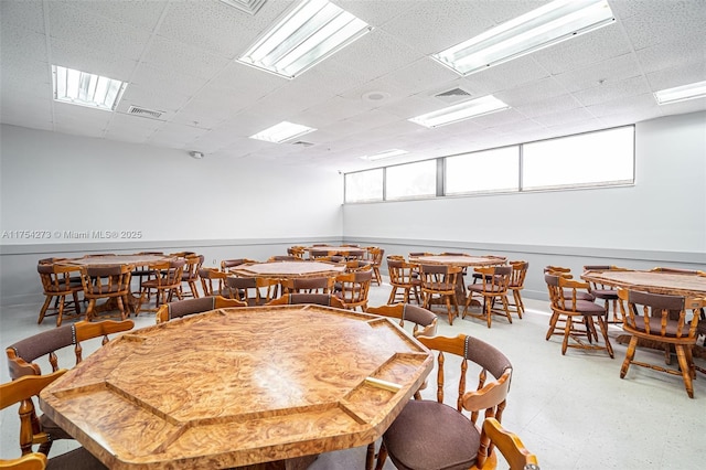 dining space with a paneled ceiling, visible vents, and tile patterned floors