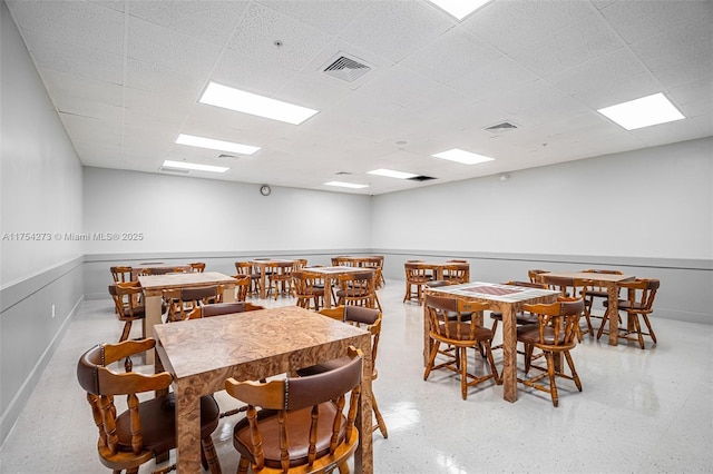 dining room featuring baseboards, visible vents, and a drop ceiling