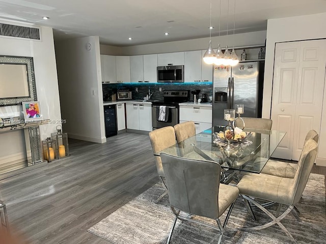 dining room with a toaster, visible vents, wine cooler, dark wood-style flooring, and recessed lighting