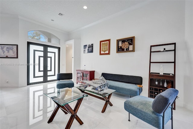 living area featuring baseboards, visible vents, ornamental molding, a textured ceiling, and french doors