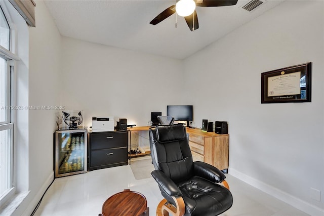 home office featuring a ceiling fan, visible vents, and baseboards