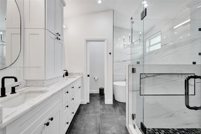 full bath with a soaking tub, a sink, and a marble finish shower