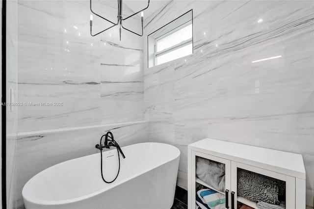 full bath with a soaking tub and tile walls