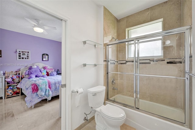 full bathroom with ensuite bathroom, combined bath / shower with glass door, toilet, and a ceiling fan