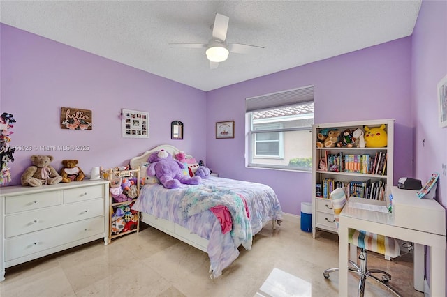 bedroom featuring a ceiling fan, a textured ceiling, and baseboards