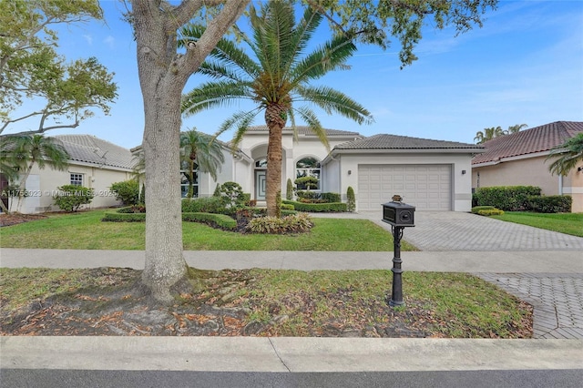 view of front of home featuring a garage, a front lawn, decorative driveway, and stucco siding