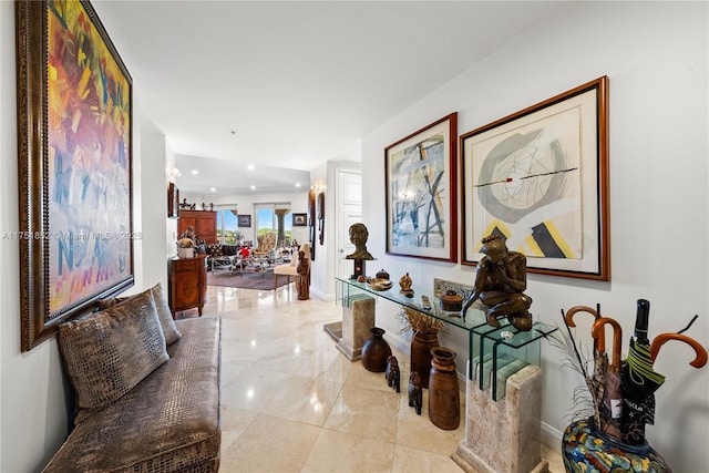 hall with marble finish floor and baseboards