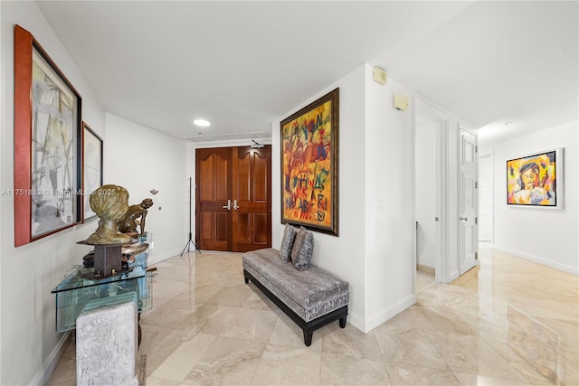 corridor with recessed lighting, marble finish floor, and baseboards