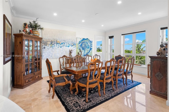 dining space with marble finish floor, ornamental molding, and baseboards