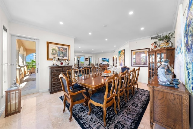 dining area with baseboards, arched walkways, crown molding, and recessed lighting