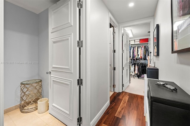 hallway featuring baseboards and dark wood finished floors