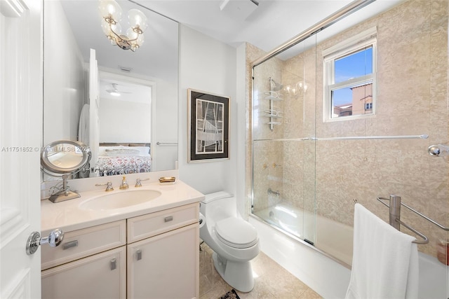 bathroom featuring toilet, shower / bath combination with glass door, vanity, and ensuite bath