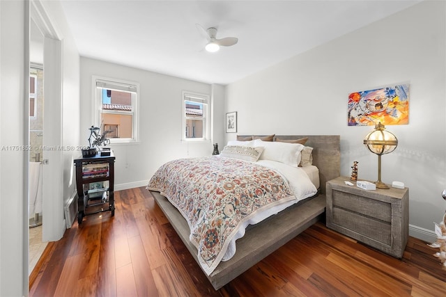 bedroom featuring ceiling fan, wood finished floors, and baseboards