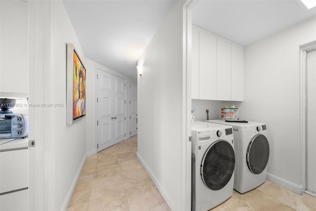 laundry room featuring baseboards, cabinet space, and washer and dryer