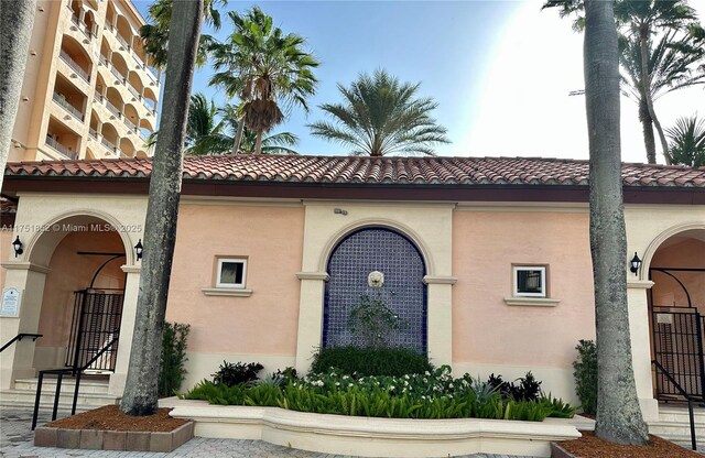 view of front of property with a tiled roof and stucco siding