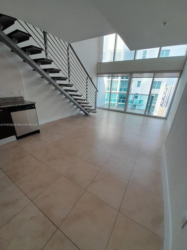 interior space with stairway and a towering ceiling