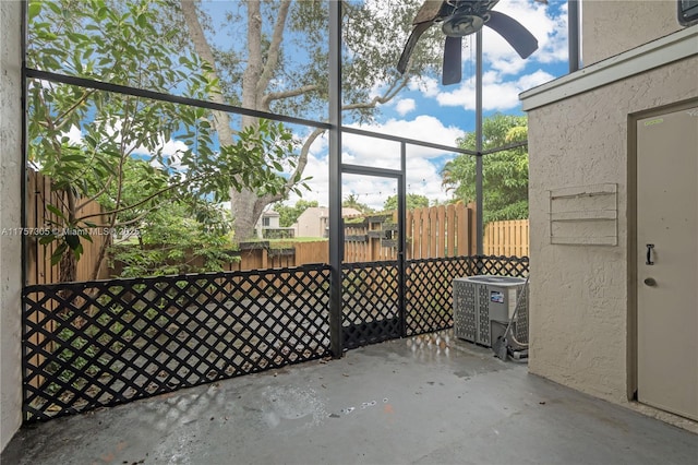 unfurnished sunroom featuring a ceiling fan