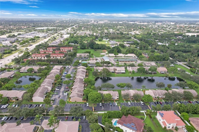 birds eye view of property featuring a water view and a residential view