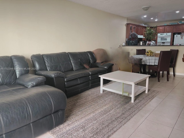 living area with light tile patterned floors and recessed lighting